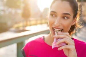 Teen volleyball player eating a pre-tournament meal of carbohydrates and protein
